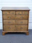 George III oak, ash and mahogany chest of two over three graduated drawers with quarter veneered top