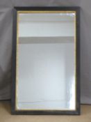 A mirror with gilt border and reeded ebonised frame, 93 x 58cm