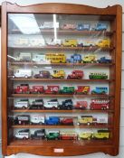 One-hundred-and-one Matchbox, Lledo and similar diecast model vehicles, in three wooden display