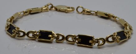 A 14k gold bracelet set with onyx