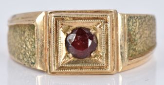 A 9ct gold signet ring set with a garnet, 6.8g, size T