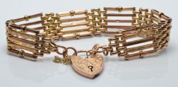 A 9ct gold bracelet with heart clasp and engraved links, 18.4g