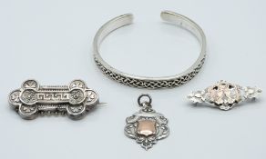A silver bangle, Victorian brooch (Birmingham 1898), silver sweetheart brooch (Glasgow 1938) and a