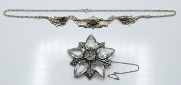 A silver necklace set with garnets and a silver brooch set with heart cut paste (55.3 diam). 38.3g