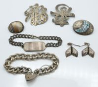 A group of silver jewellery to include two Japanese brooches, curb link bracelet, identity bracelet,