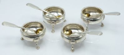 A set of four hallmarked silver salts raised on hoof feet and with shell decoration, together with