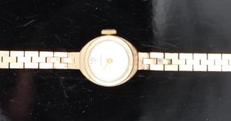 Garrard 9ct gold ladies wristwatch with gold hands and hour markers and silver dial, on 9ct gold