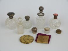 Two hallmarked silver topped dressing table bottles including an inlaid tortoiseshell example,