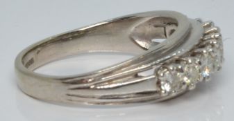 An 18ct white gold ring set with nine round cut diamonds, each approximately 0.1ct, 5.1g, size Q/R