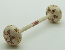 A 19thC Indian Madras ware ivory baby's rattle in the form of a dumbell, length 12.5cm