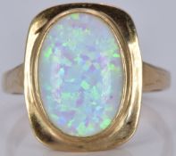 A 9ct gold ring set with a synthetic opal, 3.8g, size M/N