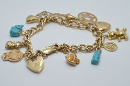 A 9ct gold charm bracelet with fourteen 9ct gold charm, 28.8g