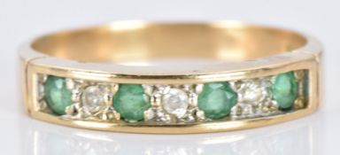 A 9ct gold ring set with alternating emeralds and diamonds, 2.3g, size O