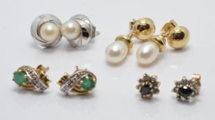 A collection of 9ct gold earrings including a white gold pair set with a pearl, emerald and