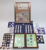 An amateur collection of coins and banknotes, some framed, including a white £5 note, coins