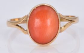 An 18ct gold ring set with a coral cabochon, 1.7g, size M