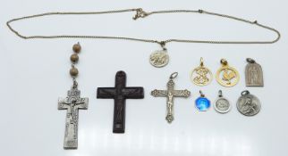 A silver crucifix, other crosses and gold plated pendants