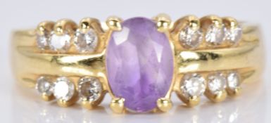 An 18ct gold ring set with an amethyst and diamonds, 4.1g, size M