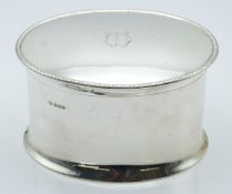 George V hallmarked silver oval biscuit barrel or similar box, with hinged lid and of waisted