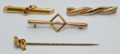 A 15ct gold brooch set with three rubies (2.1g),a 15ct gold stick pin set with a sapphire and seed