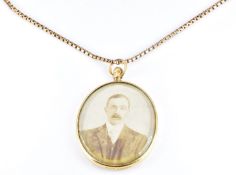A double sided Edwardian locket (2.5 x 3cm) with 9ct gold edge, Birmingham 1904, on a 9ct gold