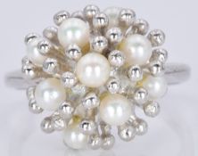 A 9ct white gold ring set with pearls in a stylised setting, 5.8g, size P