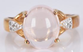 A 9ct gold ring set with a morganite cabochon and diamonds, 5.2g, size M