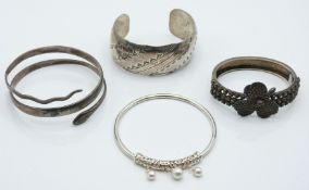 Victorian bangle set with a textured shamrock, a Russian silver niello snake bangle, a silver bangle