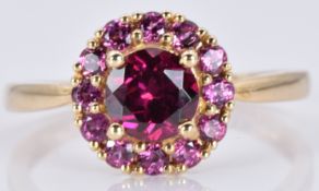 A 9ct gold ring with a rhodalite garnet and amethysts, 2.1, size N