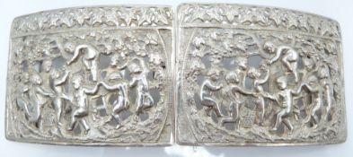 Continental white metal belt buckle with cast and pierced decoration of children celebrating the
