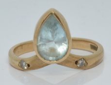A 9ct gold ring set with a pear cut aquamarine and diamonds, 2.4g, size M