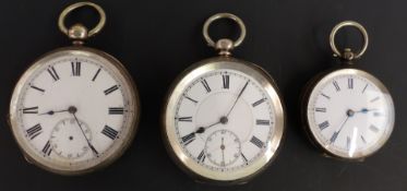 Three silver open faced pocket watches all with black Roman numerals and white enamel dials, largest