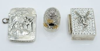 White metal vesta case with embossed decoration of a man playing the lute to two ladies, height 4.