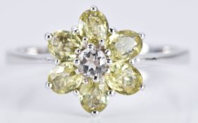 A 9ct white gold ring set with Mali garnets and white topaz in a flower cluster, 2.5g, size N