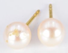 A pair of yellow metal earrings set with pearls