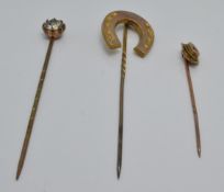 A 9ct gold stick pin set with a diamond, a Victorian yellow metal stick pin in the form of a horse