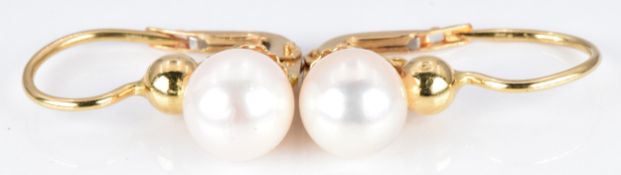 A pair of 18ct gold earrings set with a pearl to each