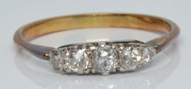 An 18ct gold ring set with five old cut diamonds, 2.9g, size R