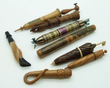 A collection of treen needle cases including Mauchline Ware parasol, deer slot, riding crop, straw
