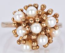 A 9ct gold ring set with pearls in a stylised setting, 4.9g, size P