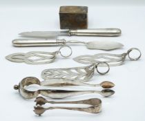 Set of three white metal asparagus or similar servers with loop handles and pierced decoration,