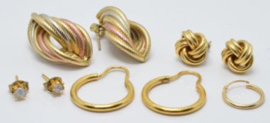 A pair of 9ct gold tri-coloured earrings (4.8g), a pair of yellow metal hoop earrings and a pair