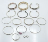 Twelve silver bangles with engraved decoration and two christening bangles, 178g