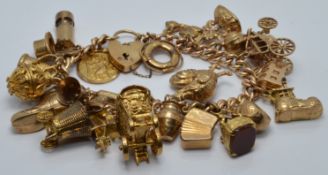 A 9ct gold charm bracelet with over 21 charms including St Christopher, carriage, fob, cockerel,