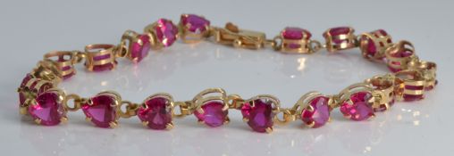 A 10k gold bracelet set with heart shaped paste
