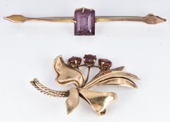 A 9ct gold brooch set with garnets in the form of a stylised bouquet and another 9ct gold brooch,
