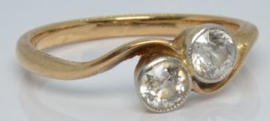 A yellow metal ring set with two diamonds, each approximately 0.2ct in a twist setting, 2.0g, size K