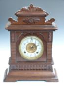 Ansonia oak cased mantel clock, with Arabic ivory coloured enamel chapter ring, beetle and poker