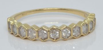 A 10k gold half eternity ring set with diamonds, with certificate, size T