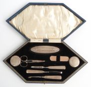 George VI cased hallmarked silver manicure set, Birmingham 1946 maker's mark KSB, width of case 31.